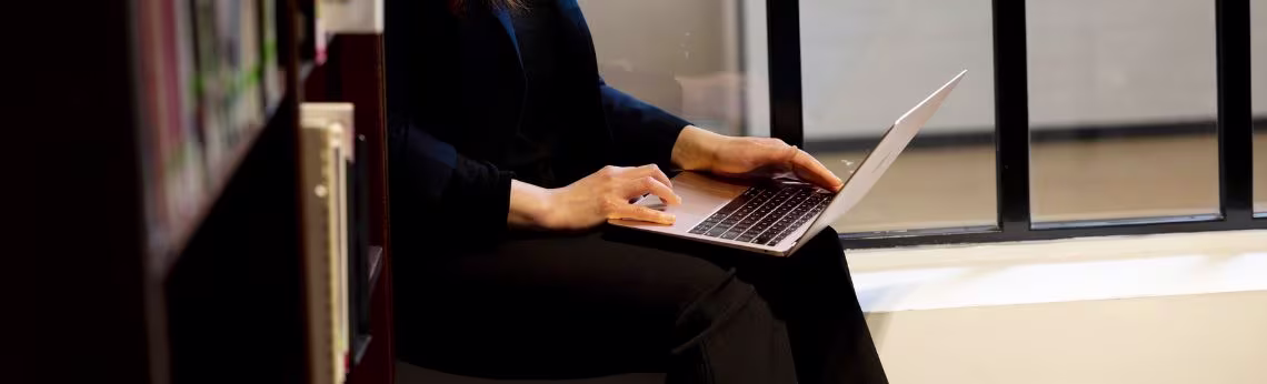 Woman views the screen of her laptop