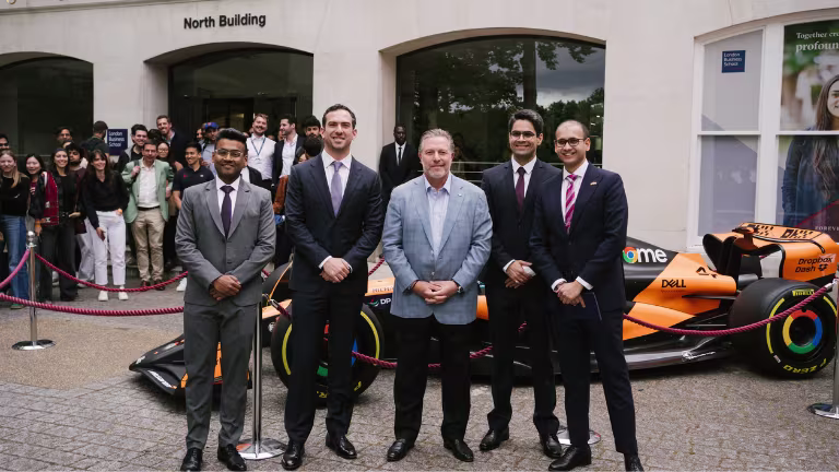 Mclaren's Zak Brown standing with a group of men outside London Business School.