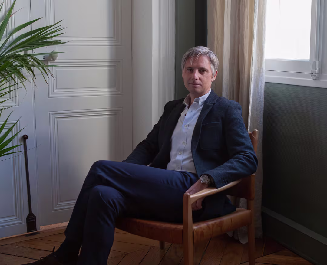 Thomas Buisson sitting in a chair